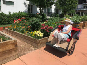 Resident of Creekside rides along the building